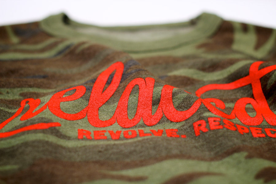 Orange Relaced logo on green and brown camo